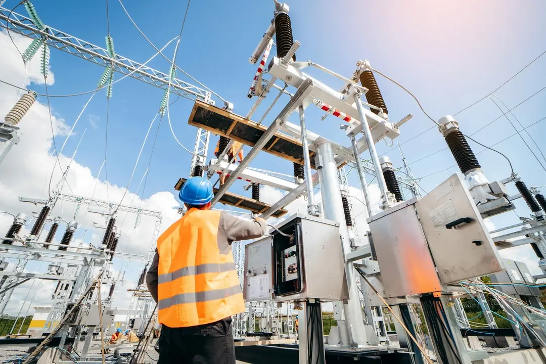 A technician works on electrical equipment